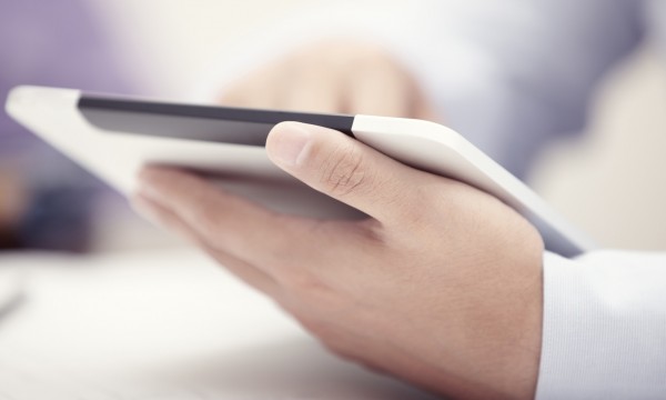 Mobile business Hands of businessman using tablet PC at office